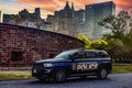New York, USA June 1, 2023: NYPD official patrol car, with the Big Apple skyline and Manhattan in the background. Royalty Free Stock Photo