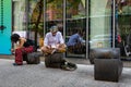 New York, USA - June 6, 2019: On the sidewalk, a man sits on a bench and reads a book - image