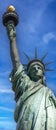 New York, USA June 1, 2023: The Statue of Liberty holding its torch under a stunning blue sky of the Big Apple. Royalty Free Stock Photo