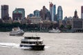 New York, USA - June 7, 2019: Tourist boats on East River in front of Manhattan, A East River ferry boat travels the Hudson River