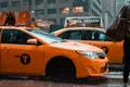 New York, USA - June 16, 2017: Yellow taxi cab speeds through busy traffic of downtown New York City on a rainy day.