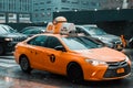 Yellow taxi cab speeds through busy traffic of downtown New York City on a rainy day. East 42nd strret, NY. Cloudy stormy weather Royalty Free Stock Photo