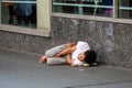 New York, USA - June 23, 2019: A young man is lying on a pedestrian sidewalk in Manhattan - image Royalty Free Stock Photo