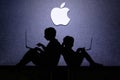 NEW YORK, USA, 25. MAY 2020: Apple American multinational technology company Children silhouette, sitting together and playing on