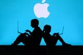 NEW YORK, USA, 25. MAY 2020: Apple American multinational technology company Children silhouette, sitting together and playing on