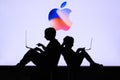 NEW YORK, USA, 25. MAY 2020: Apple American multinational technology company Children silhouette, sitting together and playing on