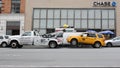Broken down yellow taxi cab being towed away by a recovery vehicle in New York Royalty Free Stock Photo
