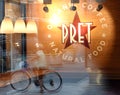 New York, USA - May 26, 2018: Fast casual restaurant Pret A Manger logo with reflection the street of New York. Royalty Free Stock Photo