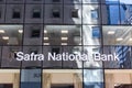 NEW YORK, USA - MAY 15, 2019: The glass windows of the Safra National Bank building reflect the facades of other