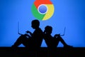 NEW YORK, USA, 25. MAY 2020: Google Chrome web browser developed by Google Children silhouette, sitting together and playing on Royalty Free Stock Photo