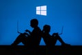 NEW YORK, USA, 25. MAY 2020: Microsoft Windows graphical operating system Children silhouette, sitting together and playing on