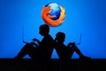 NEW YORK, USA, 25. MAY 2020: Mozilla Firefox web browser Children silhouette, sitting together and playing on their laptops. Royalty Free Stock Photo