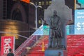 The statue of Father Duffy with street signs in Times Square, NYC