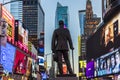 Neon advertising of News, brands and theaters at times square with statue of George M. Cohan in early morning