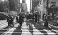 people hurry at the pedestrian way in late afternoon through upper Manhattan