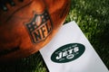NEW YORK, USA, SEPTEMBER 11, 2023: New York Jets logo on the ground and official NFL ball on green grass. Jets card, edit space Royalty Free Stock Photo