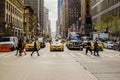 NEW YORK, NY, USA - SEPTEMBER 2017: Manhattan street with yellow taxi crossing the road