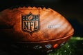 NEW YORK, USA, SEPTEMBER 11, 2023: NFL Leather Ball and Emblem in Focus. National Football League official ball Royalty Free Stock Photo