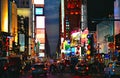 New York USA, urban night scene, colors and neon commercial lights and big traffic with colorful cars in Time Square in Manhattan Royalty Free Stock Photo