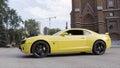 New York, USA, 08.29.2020: Yellow supercar Chevrolet Camaro in the city street. Action. Side view of a luxury muscle car