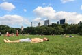 A young guy sunbathing on the grass at the Central Park. Travel around America. Royalty Free Stock Photo