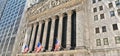 New York, Wall Street stock exchange with classic columns and old architecture and colorful flags of united states of Royalty Free Stock Photo