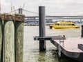 New York Water Taxi steams in front of Brooklyn Bridge, near Pie Royalty Free Stock Photo