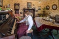 Elderly retired woman plays piano at her home.