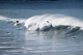Surfers surfing on huge ocean waves in New Zealand
