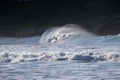 NEW ZEALAND, CHRISTCHURCH - JULY 2016: Surfer on surfing on huge ocean waves. Extreme sports in New Zealand. Summer vacation.