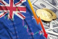 New Zealand flag and cryptocurrency falling trend with two bitcoins on dollar bills Royalty Free Stock Photo