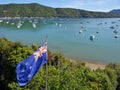 New Zealand Flag Proudly Fluttering in Marlborough Sounds Royalty Free Stock Photo