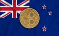 New Zealand flag, ripple gold coin on flag background. The concept of blockchain, bitcoin, currency decentralization in the