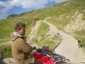 New Zealand hill country farmer on quadbike with sheep dogs Royalty Free Stock Photo
