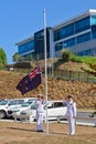 New Zealand Navy personnel lowering the NZ flag