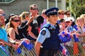 New Zealand police officer woman guarding crowd of people