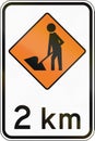 New Zealand road sign - Road workers ahead in 2 kilometres