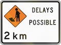 New Zealand road sign - Road workers ahead in 2 kilometres, delays possible