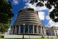 The Beehive, New Zealand`s parliament building with the New Zealand flag flying against a blue sky Royalty Free Stock Photo