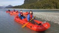 Leisure activity of couple kayaks down Dart River, New Zealand Royalty Free Stock Photo