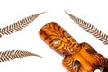 New zealand symbol, traditional maori carving and silver fern leaves, white background, close up Royalty Free Stock Photo