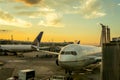 Landscape sunset view of ground operations around two jet airliners parked at United Airlines