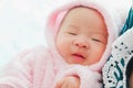 A newborn Asian baby boy in the mother`s embrace, Charming black-eyed baby 4 month old smile and happy ,A cute child hug his Royalty Free Stock Photo