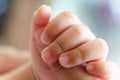 Newborn Asian baby left hand holding finger of her mother Royalty Free Stock Photo