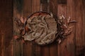 Newborn autumn background - wooden bowl with fall leaves and cream pumpkins on dark wooden planks backdrop Royalty Free Stock Photo