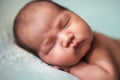 Newborn baby asian boy sleeping at blue background Royalty Free Stock Photo