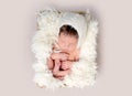 Newborn baby asleep on back with legs curled up Royalty Free Stock Photo
