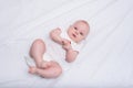 Newborn baby asleep on white blanket. Cute baby in diapers on the white sheets. Top view Royalty Free Stock Photo