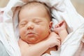 Newborn baby in bedsheet