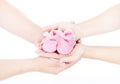 Newborn Baby Booties in Family Hands, Parents Couple Holding New Born Kids Clothing